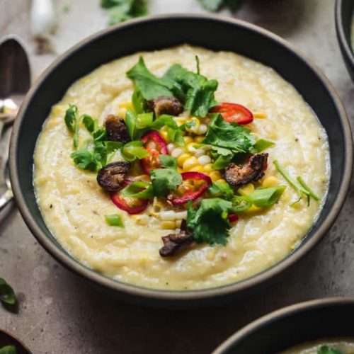 Vegan-Corn-Chowder topeed with dates and cilantro in a brown bowl.