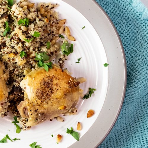 Baked chicken and quinoa in a plate.