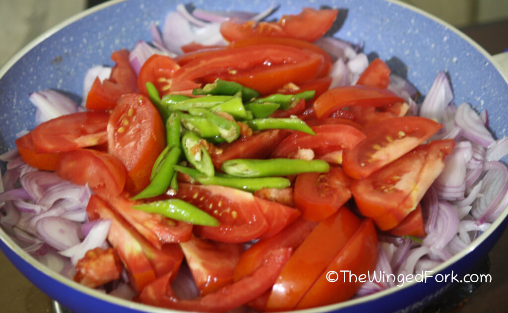 Step 4 - Put the onions, chillies and tomatoes in a frying pan