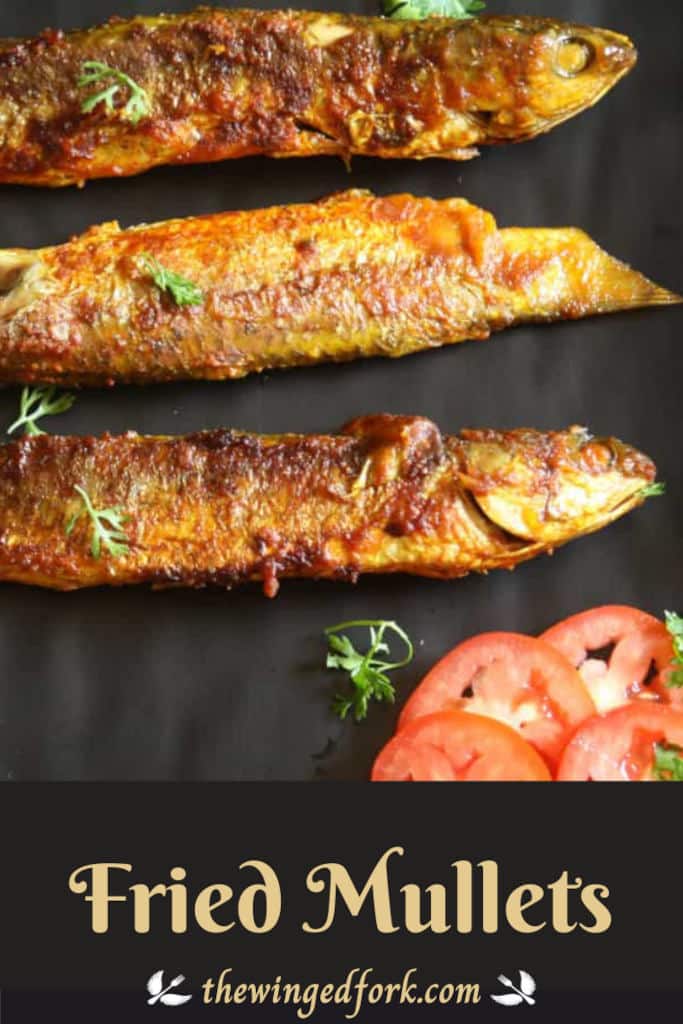 Pinterest image of 3 fried mullets in a black tray with tomatoes and coriander.