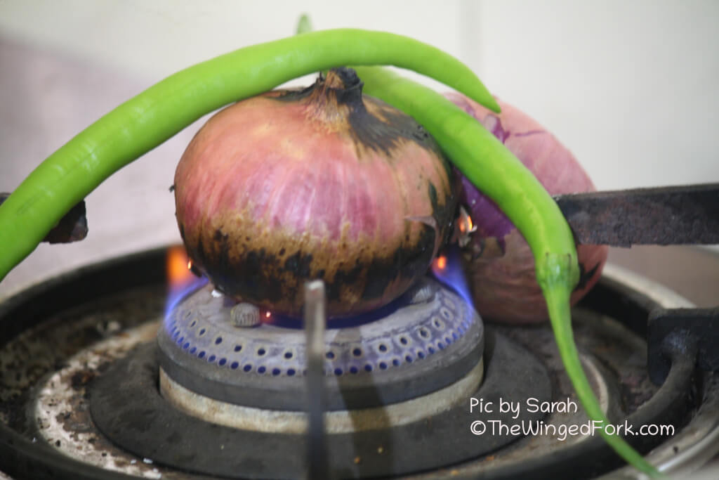 Slit the chillies and roast them with the onions