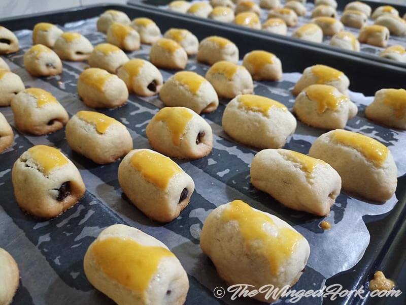 East Indian Date Rolls on a baking tray fresh out of the oven