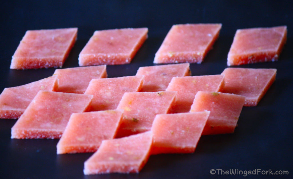 Slices of Guava cheese placed on a black serving board. 