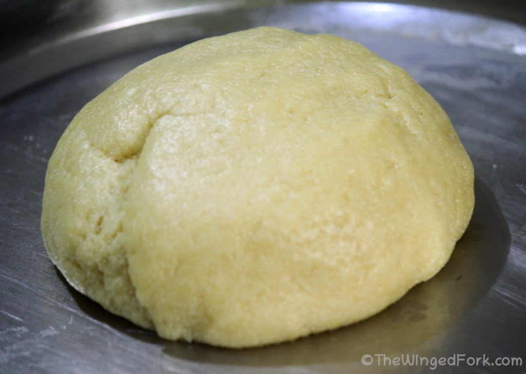 A ball of dough on a steel thali.