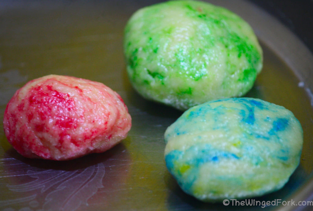 Blue, pink and green marble dough on a thali.