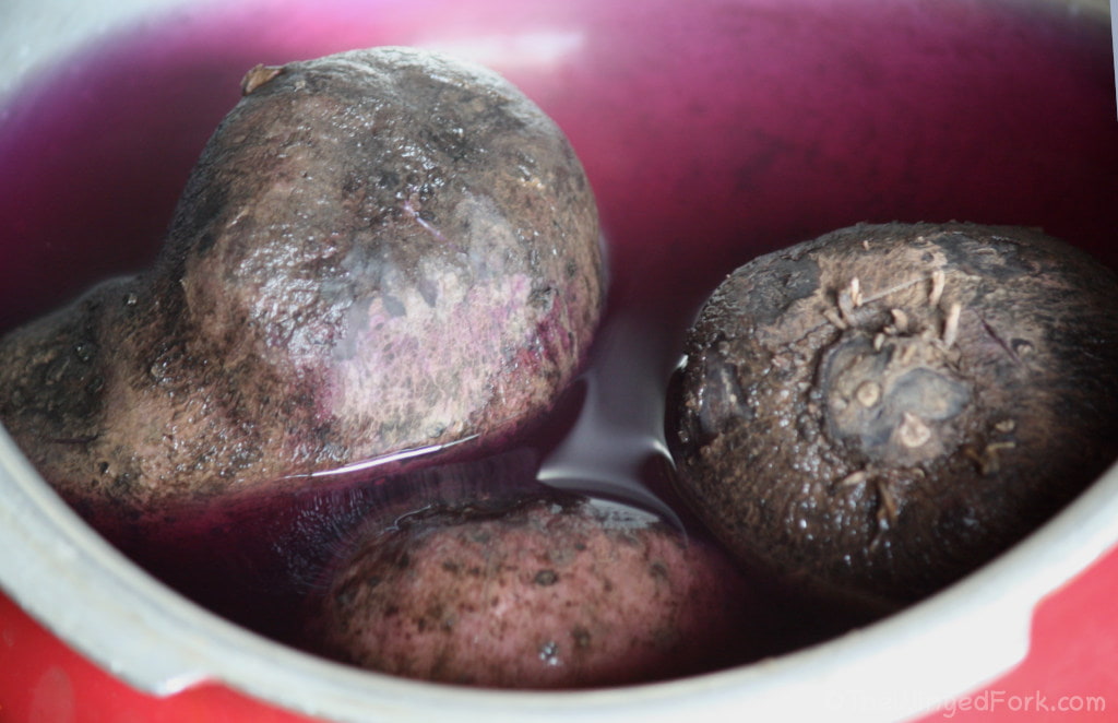 Purple Yams in a pressure cooker with purple water.