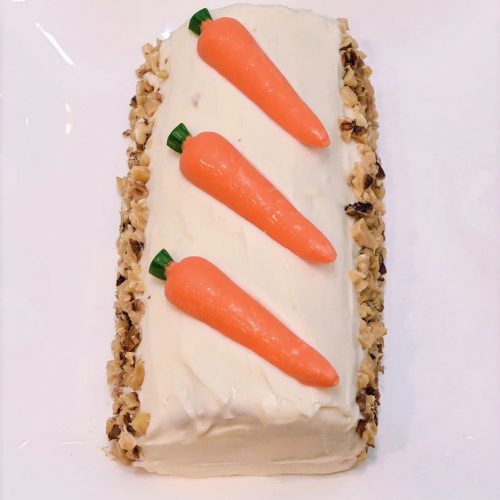 Easter carrot cake with 3 carrots on top.