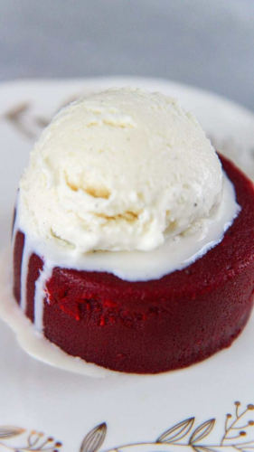 Red velvet lava cake with a scoop of vanilla ice cream.