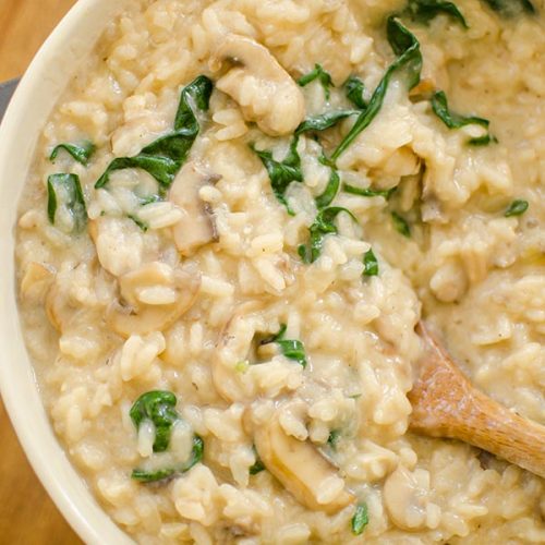 Spinach and mushroom risotto in a bowl.