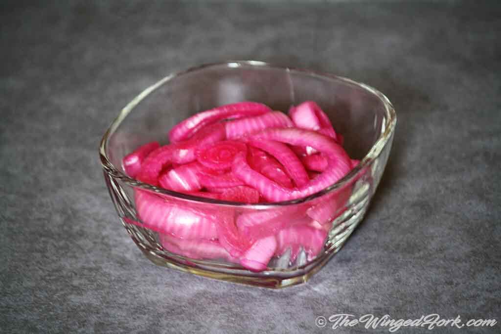 Separate onion rings marinated with beetroot gives the colour.