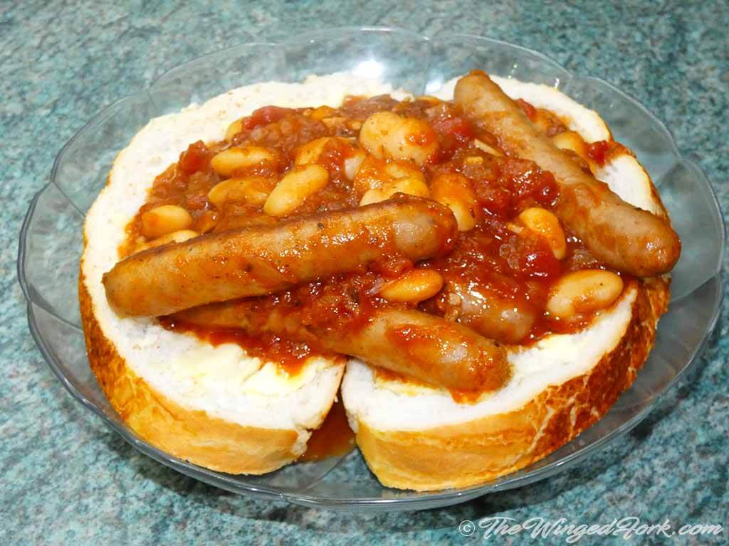 Sausage casserole on a tiger bread in a glass plate.