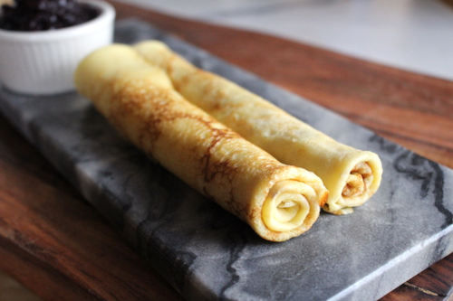 2 Norwegian rolled Pancakes on a grey platter.