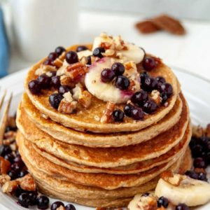 Oatmeal Cootage cheese pancakes topped with bananas and berries.