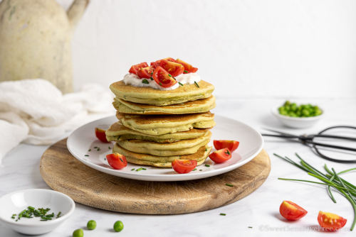 Savoury Pancakes with green pea flour topped with chopped tomatoes and chives.