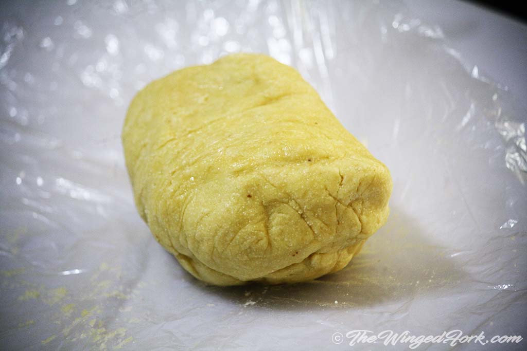 A ball of dough on a sheet of cling film. st in the refrigerator.