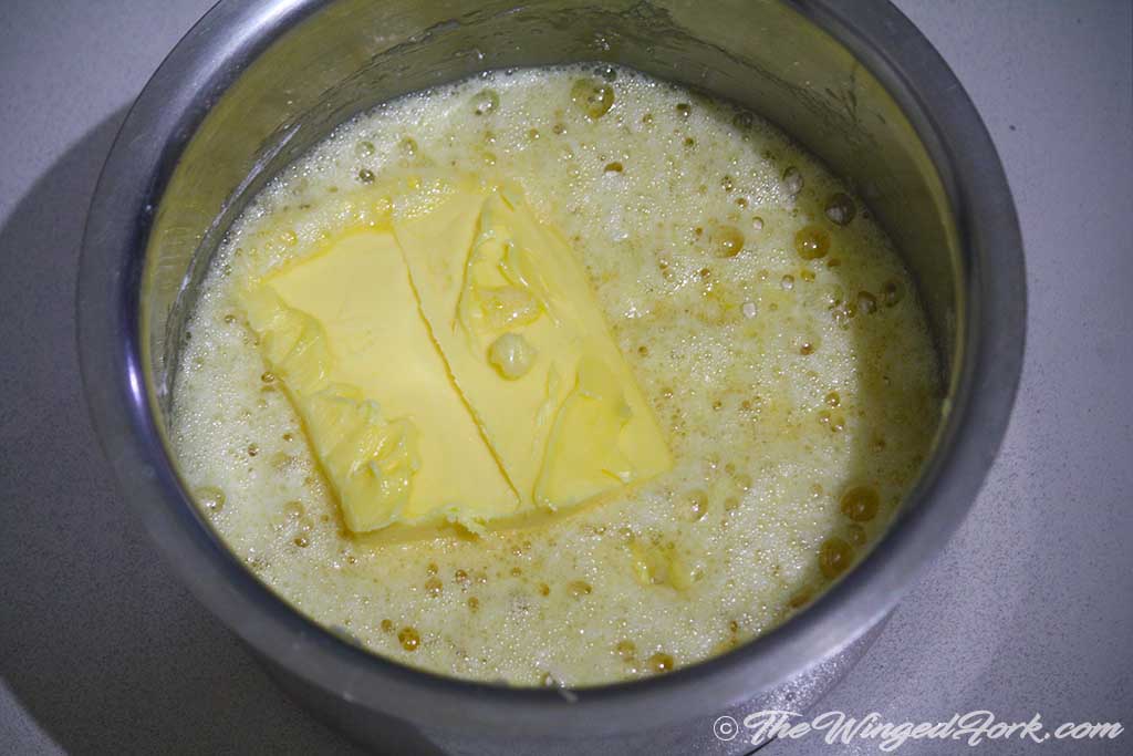 Add butter to the beaten eggs.