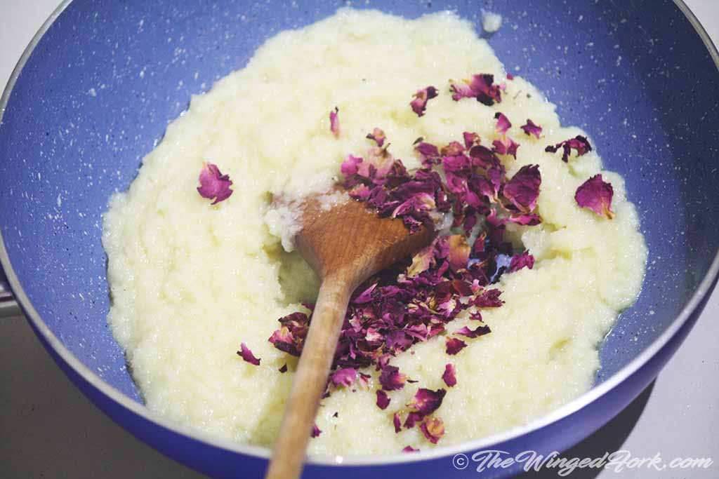 Add the dried rose petals to the cooked coconut barfi.