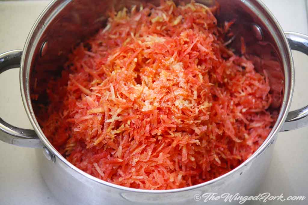 Add the grated carrots to the melted ghee.