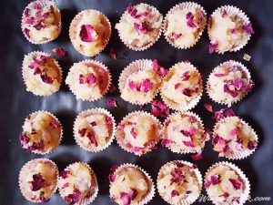 Muffin liners of coconut barfi covered with rose petals.