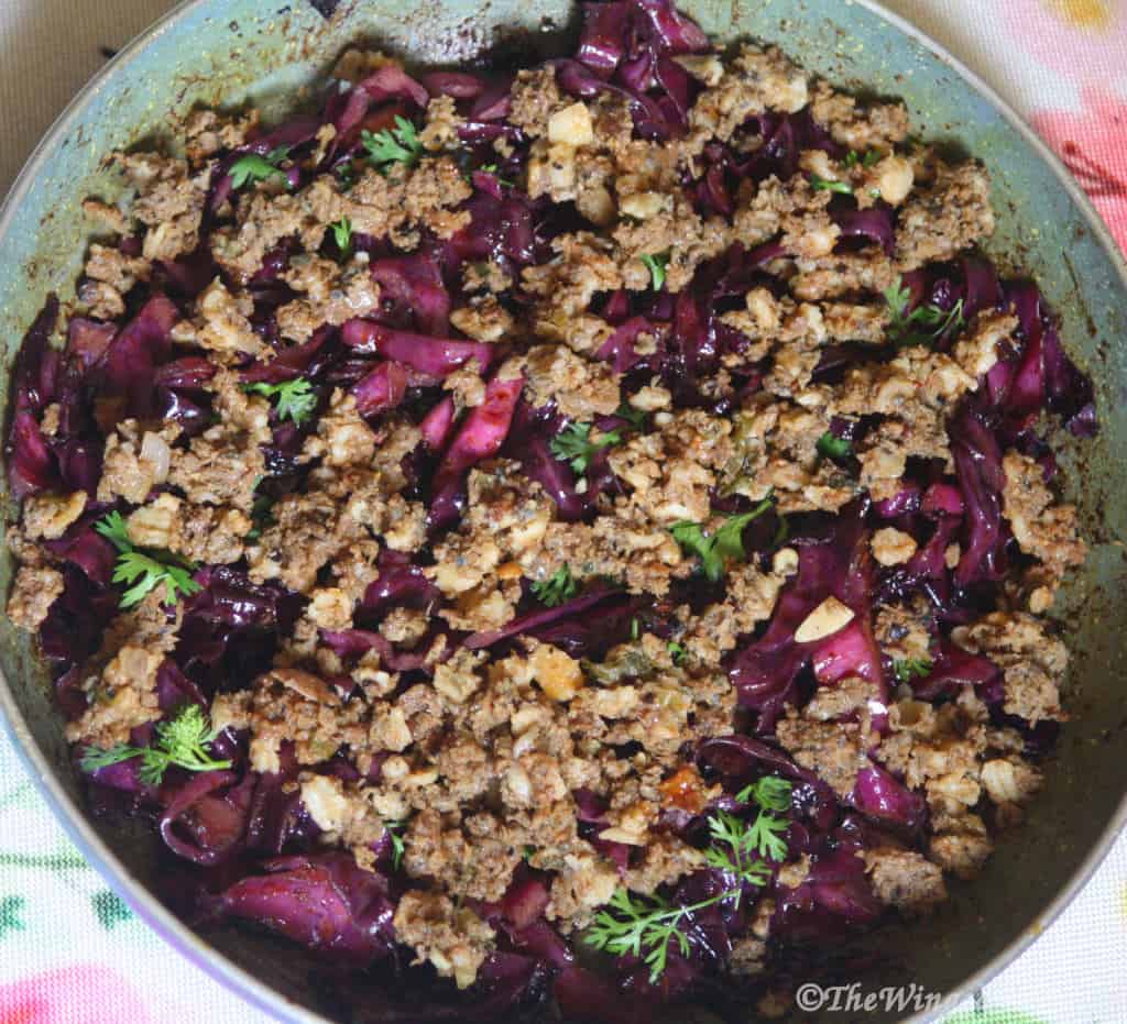 Purple cabbage stir fry with minced beef in a pan.