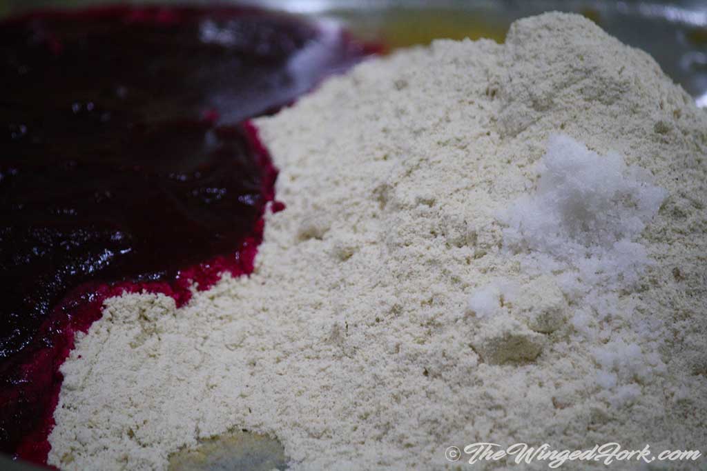 Beetroot pulp, whole wheat flour and pinch of salt in a plate.