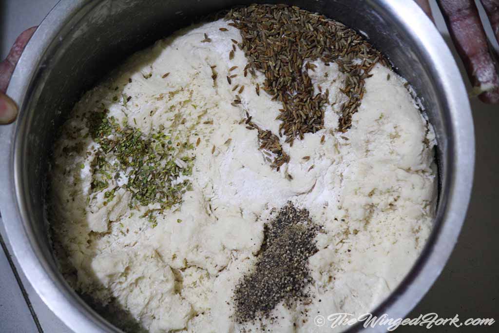 Add cumin, pepper, herb to the flour in a vessel