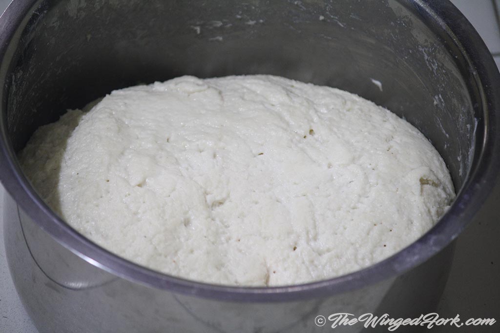 Rested risen dough in a vessel.
