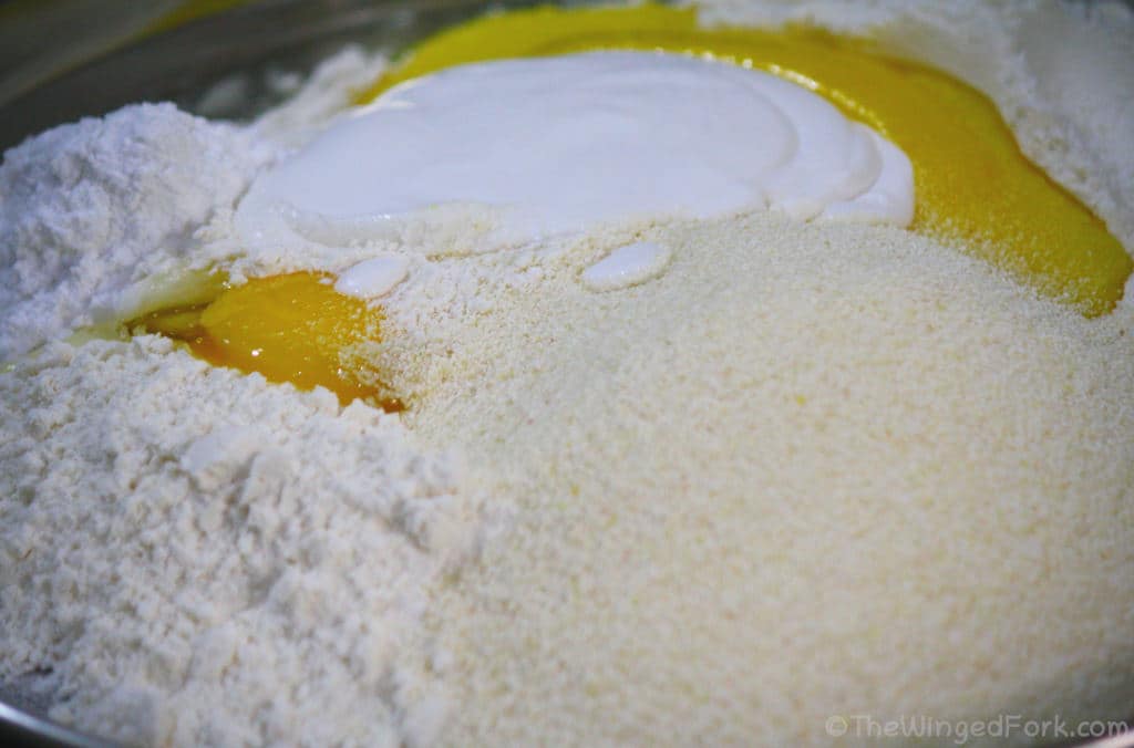 Sojee, flour, sugar, egg, ghee and coconut milk in a thali.
