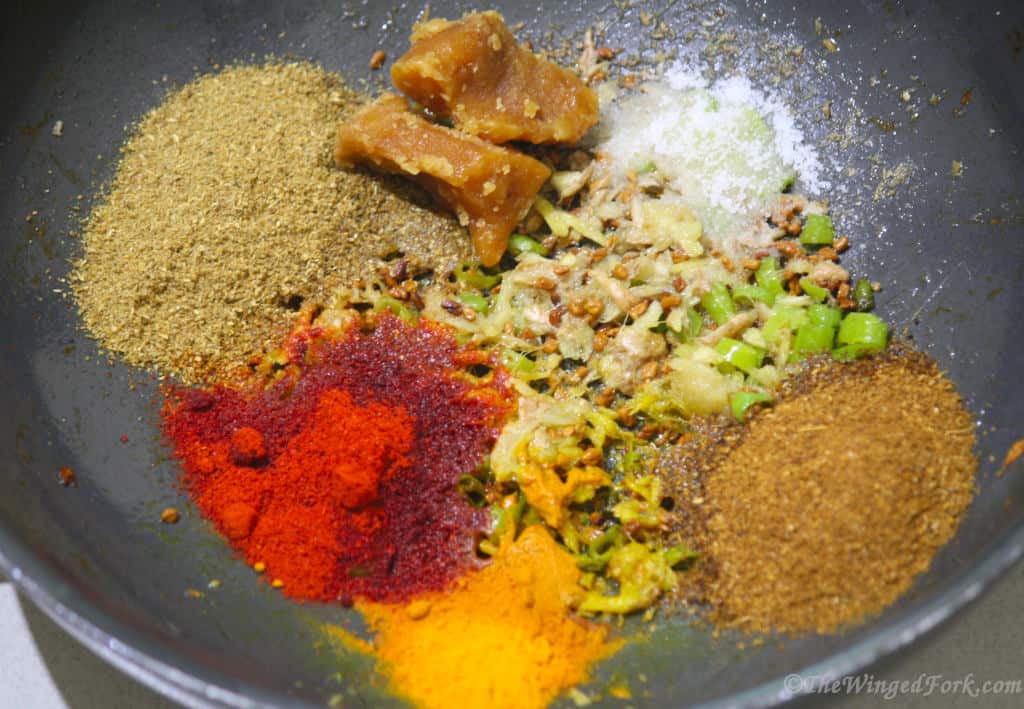 Various spices and jaggery added to the pan.