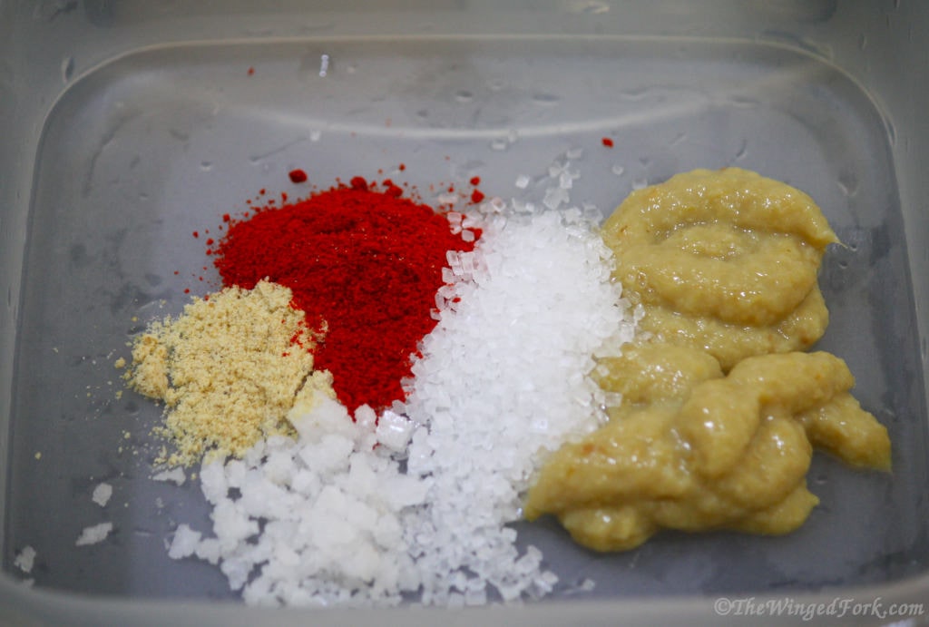 Sugar, ginger garlic paste, salt, red chili powder and hing in a vessel.