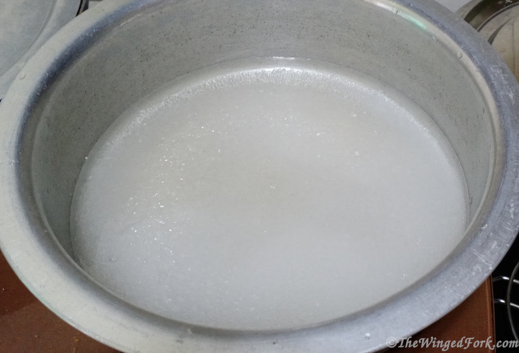 Water and sugar in a vessel.