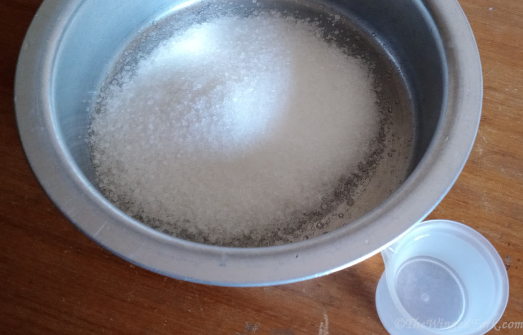 Sugar in a vessel and water in a bowl.