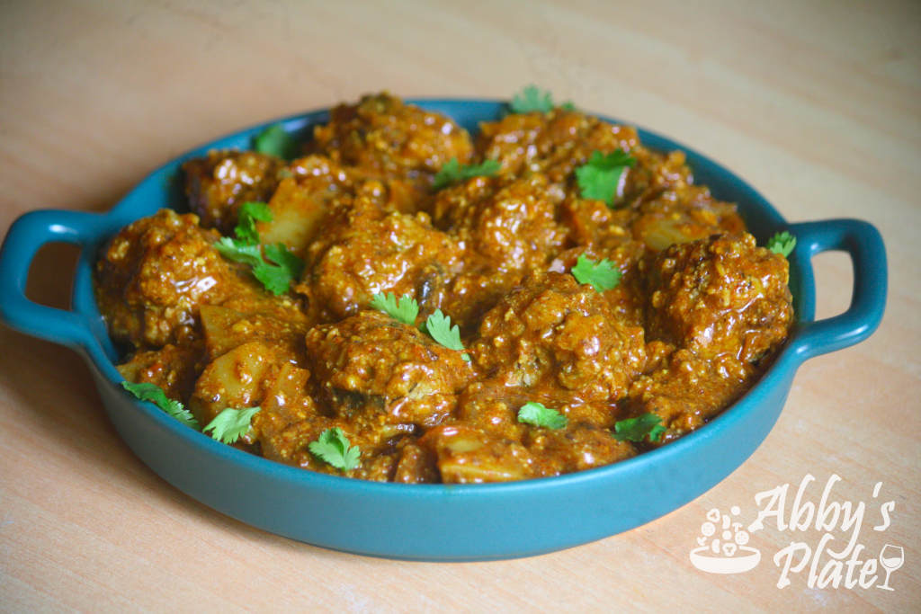 East Indian meatball curry in a green platter.