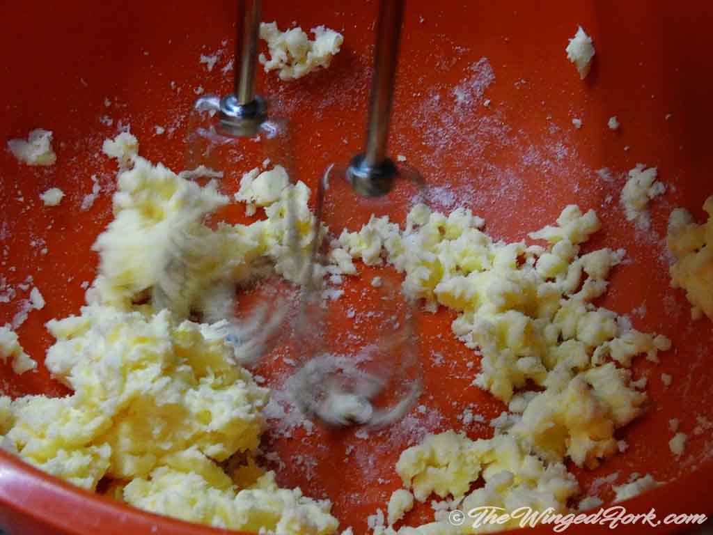 Mix butter and sugar together with a blender.
