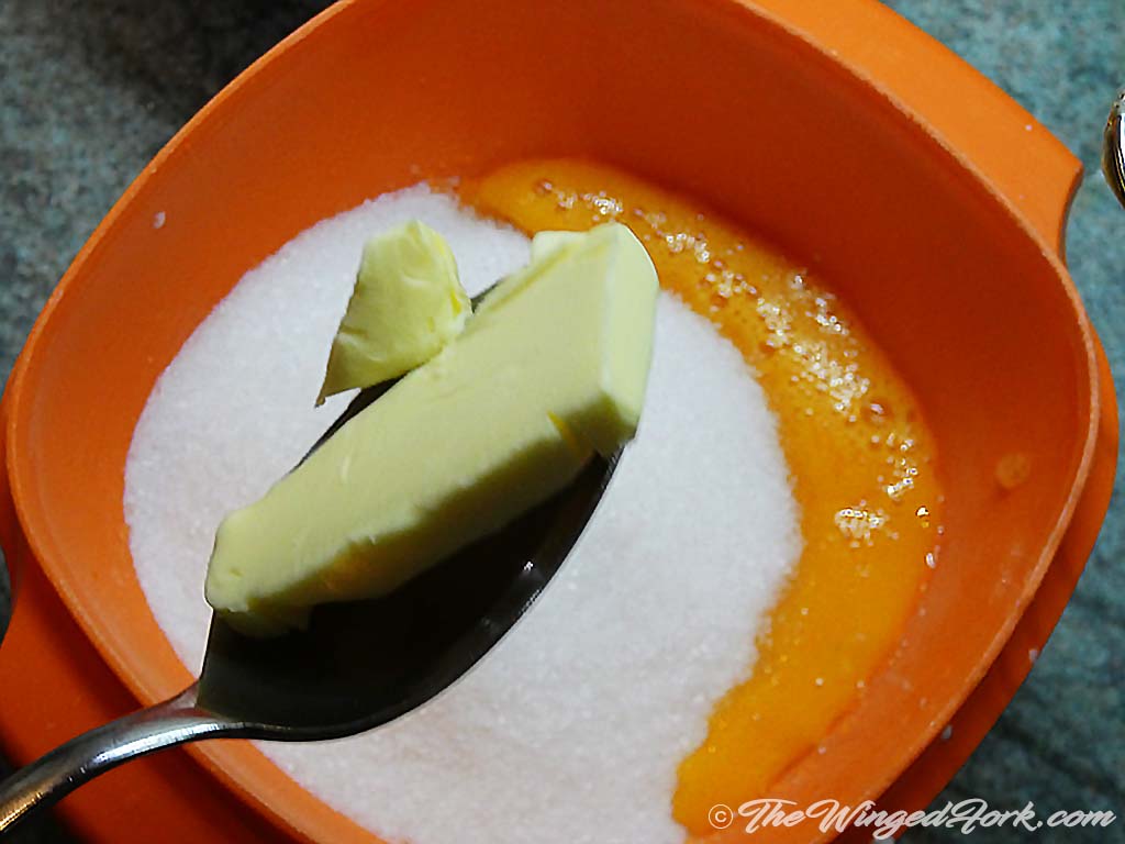 Add butter and sugar to the egg yolk in a bowl.