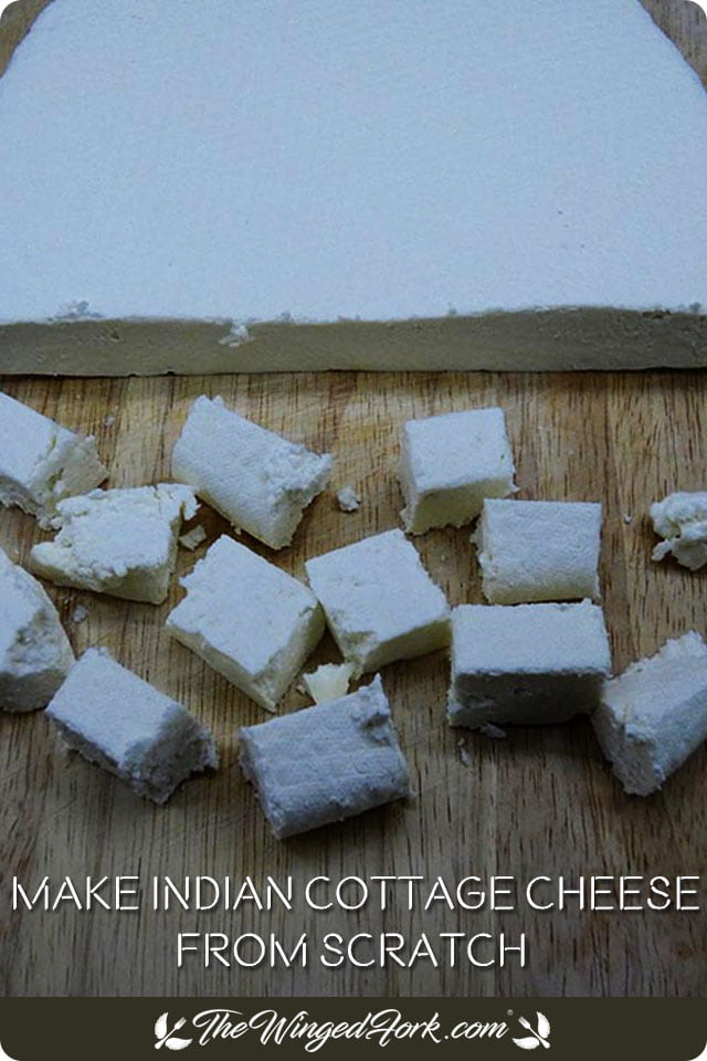 Pinterest image of paneer slab cut into cubes.