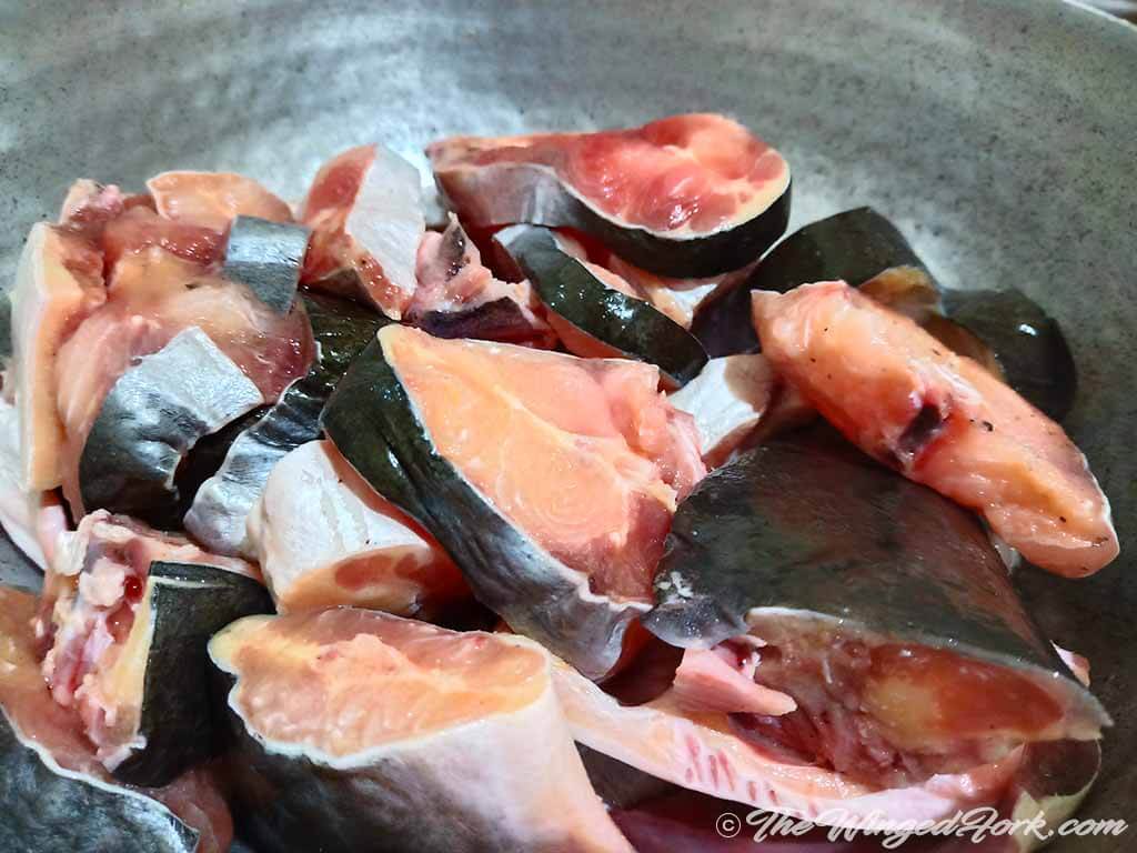 Cut pieces of Baiki fish in a kadai.