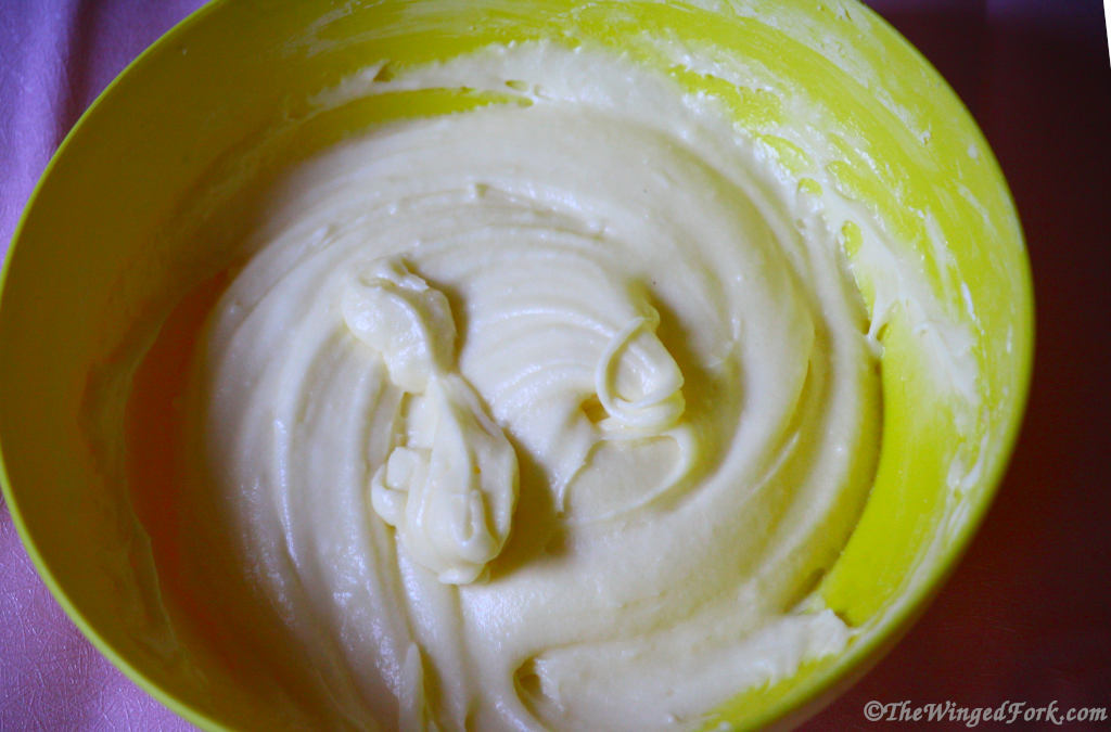 Cream cheese frosting in a yellow bowl.