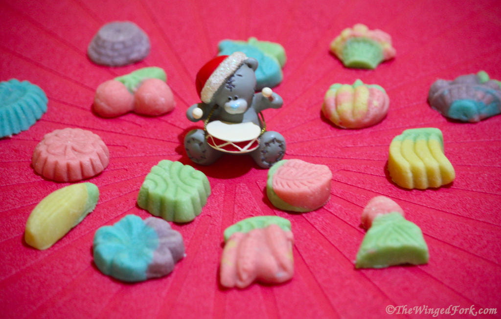 Colourful marzipan on a red tablecloth with a drummer bear.