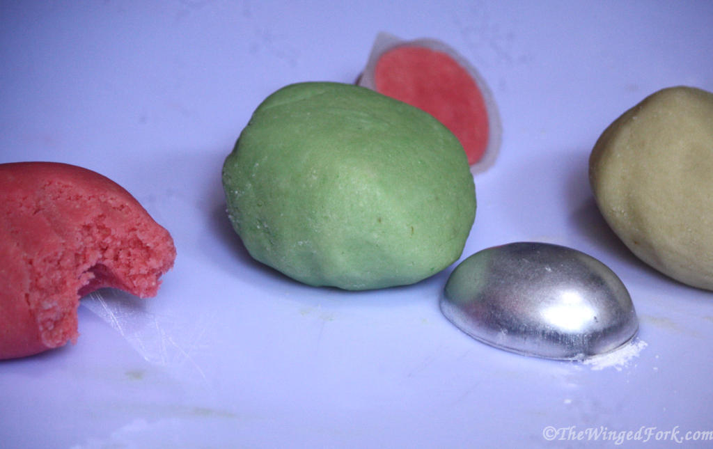 Pink, green and white ball of marzipan.