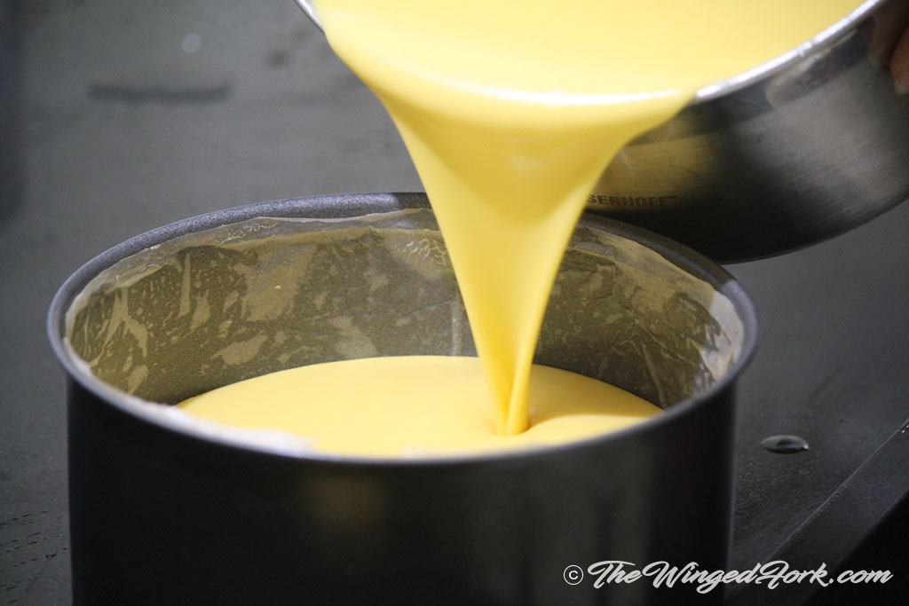 Pour mango mousse till you reach half the tin level.