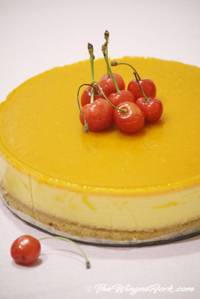 Delicious veg mango cheesecake topped with cherries.