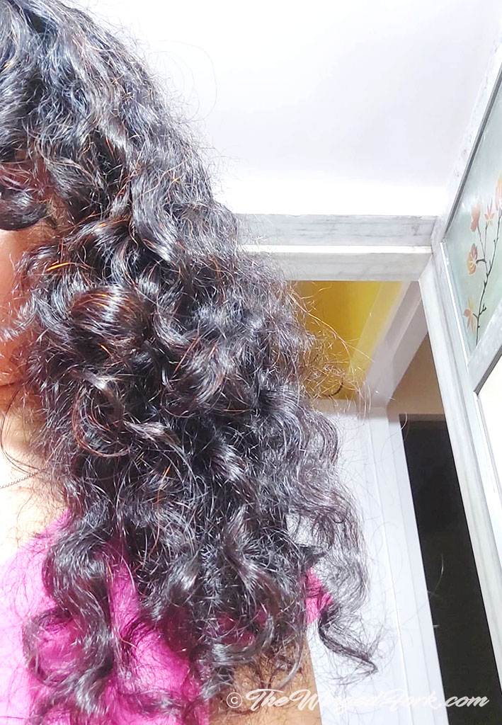 Girl with shiny curly hair.