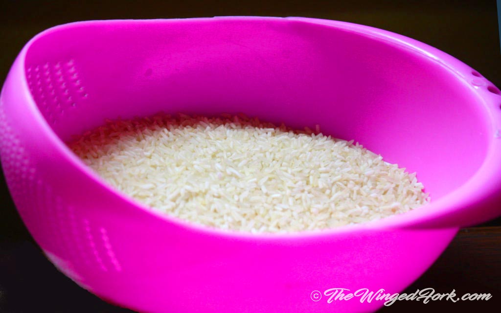 Plain white rice in a sieve.