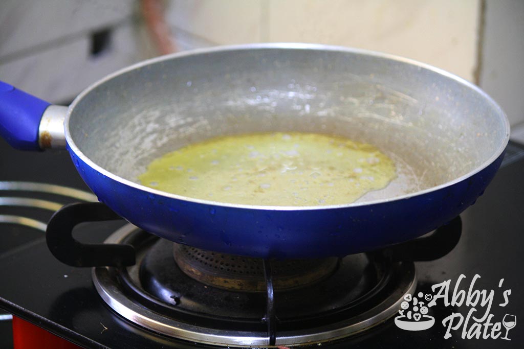 Ghee or Indian clarified butter heating in a pan.
