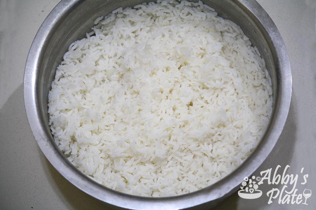Boiled white rice in a steel pot.
