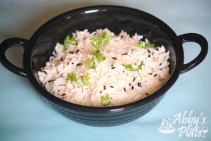 indian cumin rice in a black bowl.