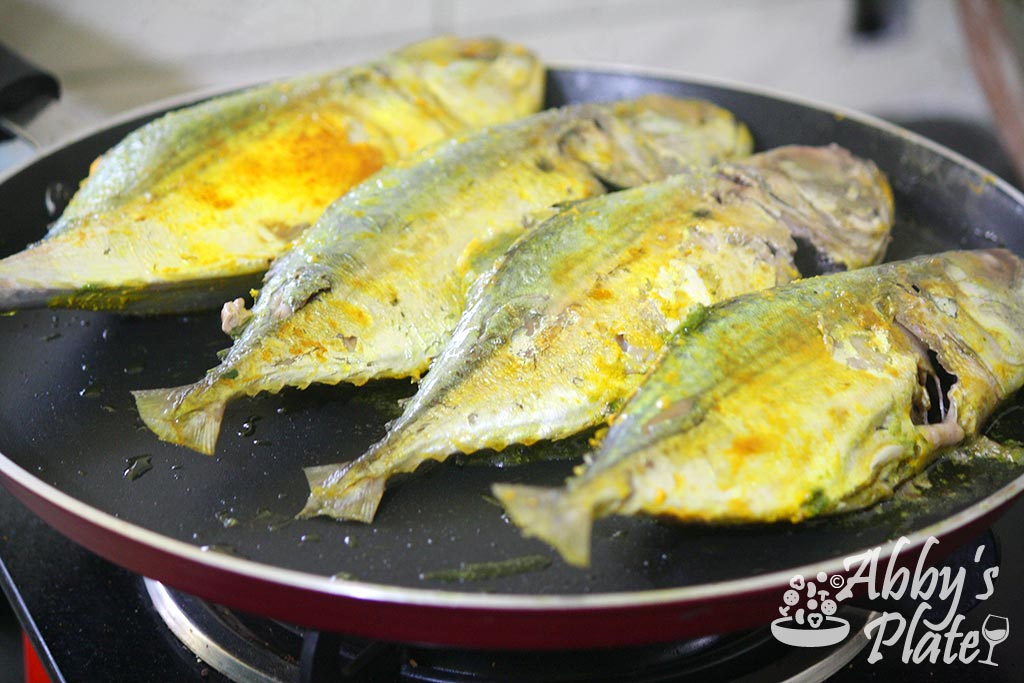 Turn the mackerels over and fry on the other side.