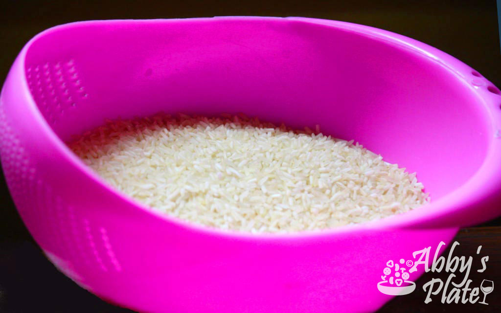 Rice in a pink sieve.