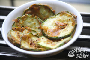 Warm fried Zucchini slices in a bowl.